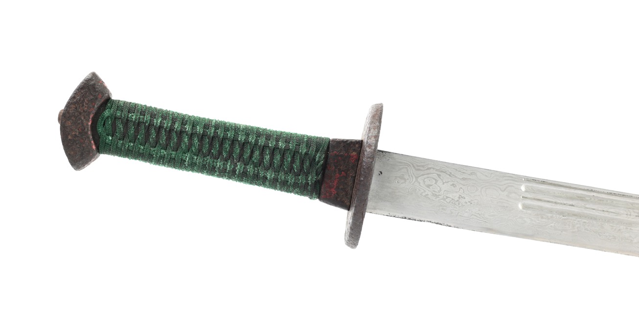 An antique Chinese saber of the 18th century with damascus blade and segmented grooves